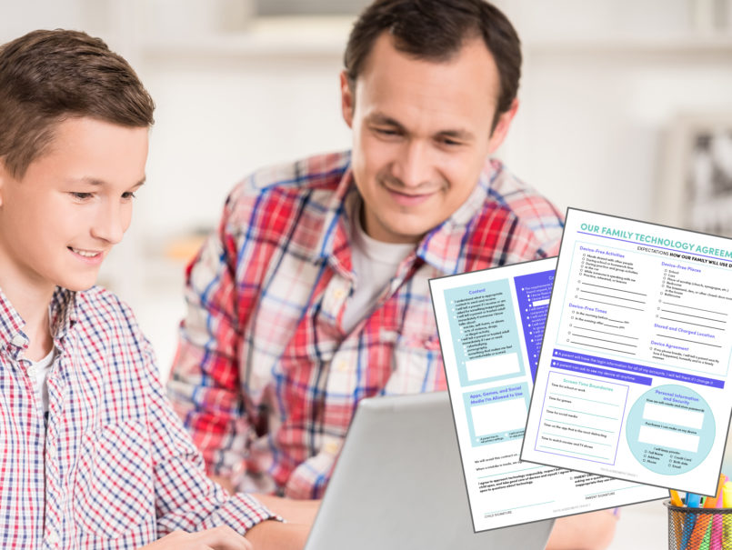 Family technology agreement dad and son looking at a laptop