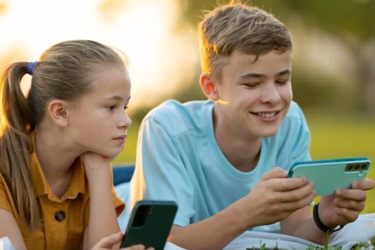 Two kids using phones with parental control app installed